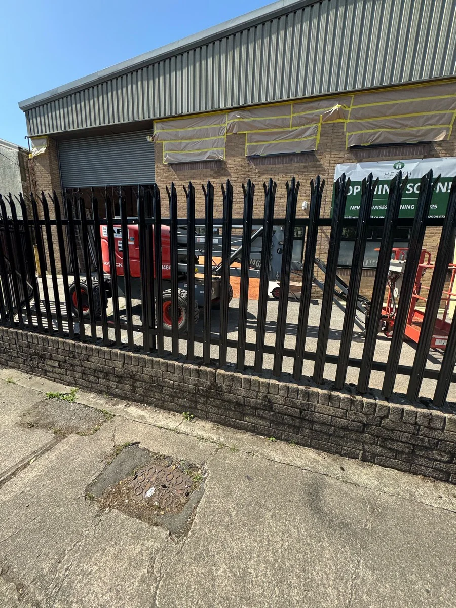 Steel palisade perimeter fencing resprayed gloss black at commercial premises, Bessemer Road Cardiff
