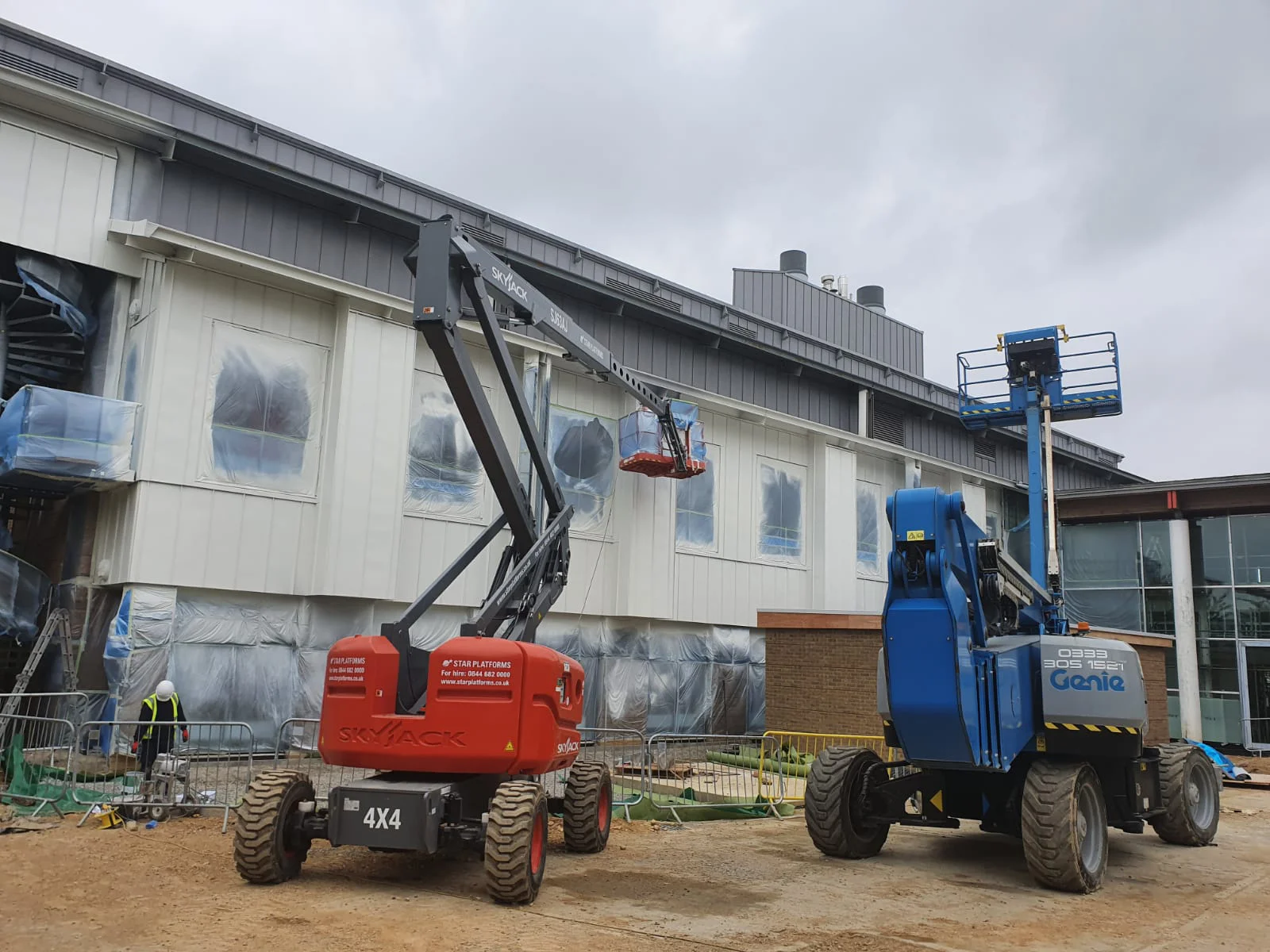 Vanda Coatings operative applying primer coat to steel cladding at Cambridge Science Park