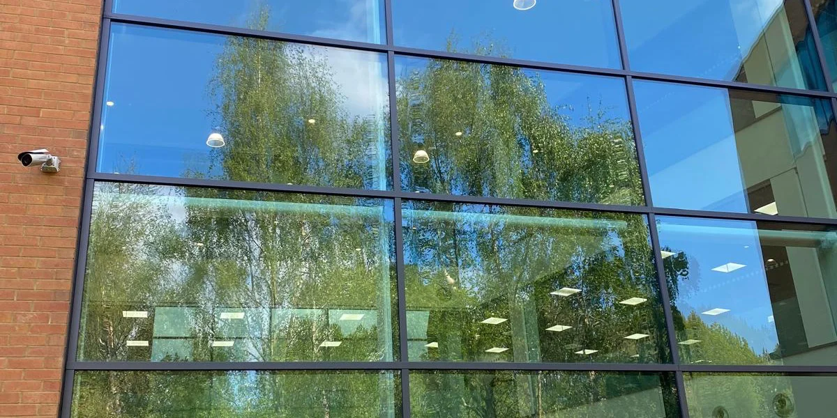 Completed curtain wall respraying at Central Park Manchester by Vanda Coatings, dark anthracite frames