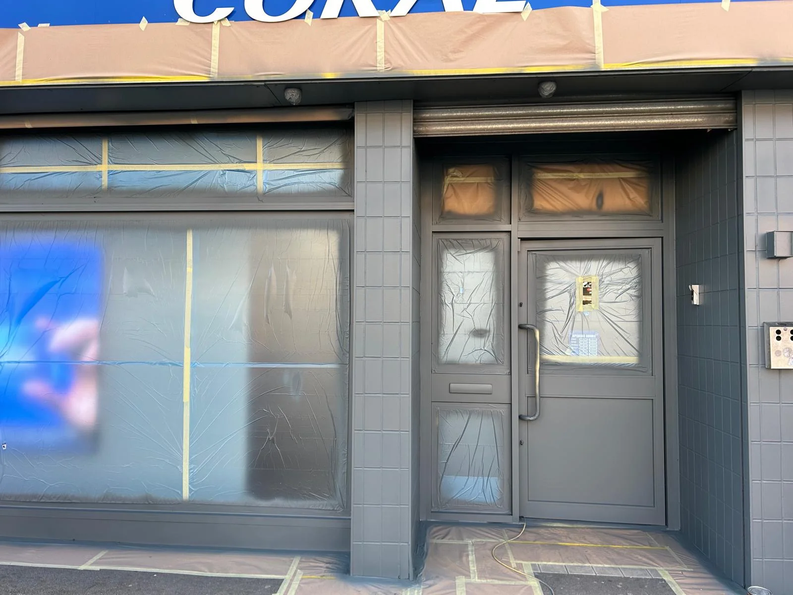 Coral Birmingham shop front after recoating by Vanda Coatings, new grey finish