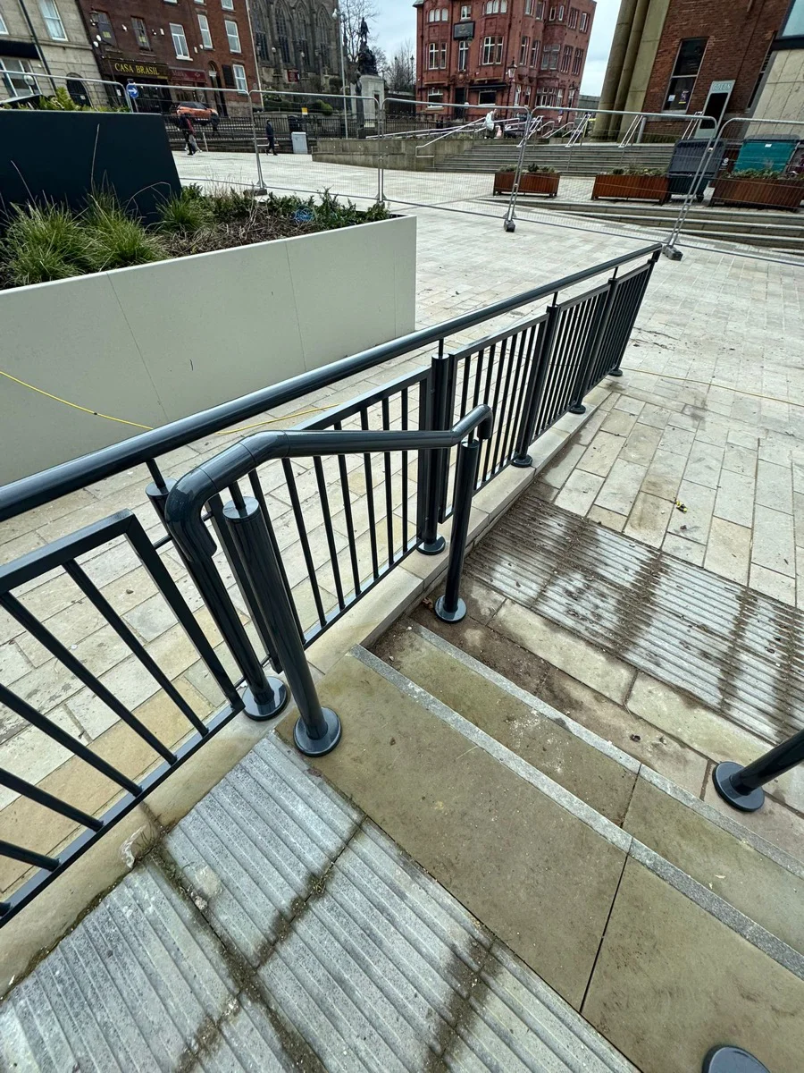 Completed balustrades on steps at Manchester city centre development, dark anthracite finish