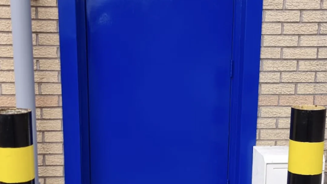 Graham's Plumbers Glasgow rear access door after recoating by Vanda Coatings, blue metal door finish
