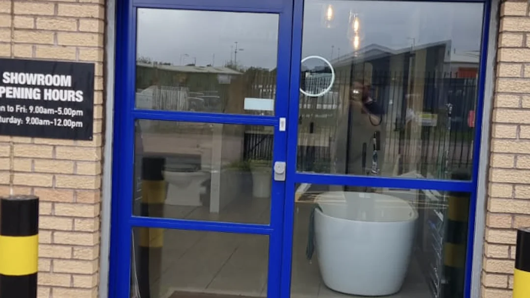 Graham's Plumbers Glasgow showroom entrance after frame recoating by Vanda Coatings, blue aluminium frames