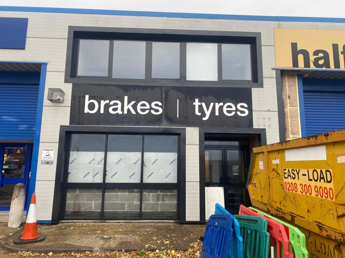 Halfords Autocentre Strood shop front after respraying, completed dark anthracite frames and fascia