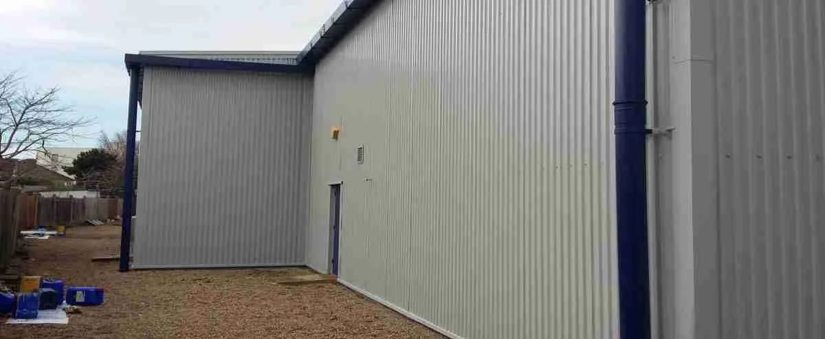 On-site recoating of PVF2 fluorocarbon cladding panels on a commercial building