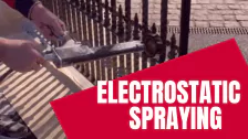 Electrostatic spray painting being applied to commercial metalwork on site
