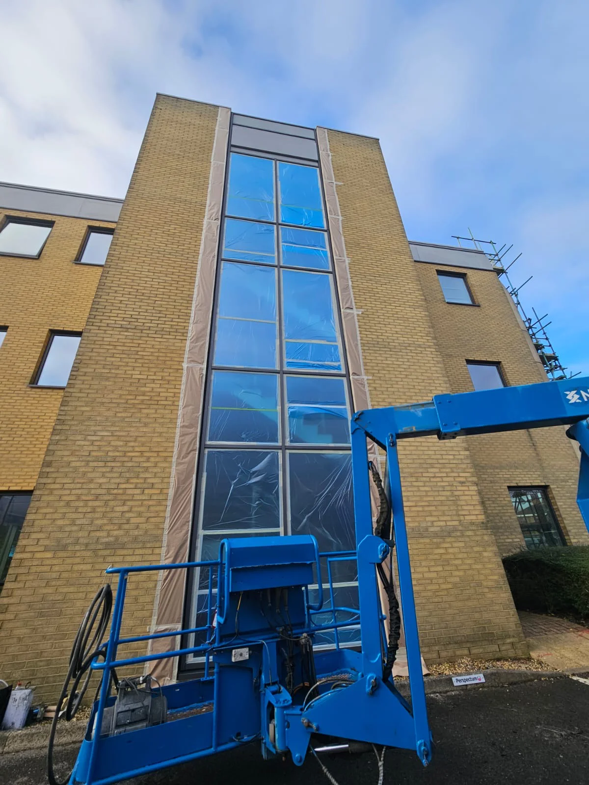 Vanda Coatings cherry picker working on curtain wall respraying at an Oxford commercial building