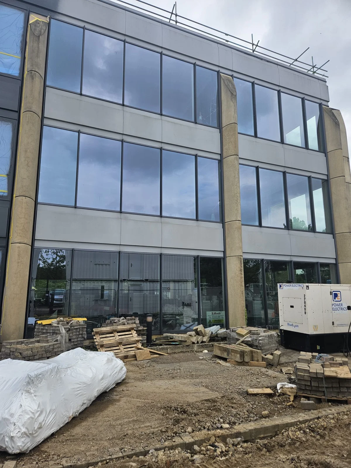 Finished aluminium curtain wall and window frames after respraying at Oxford commercial office building by Vanda Coatings