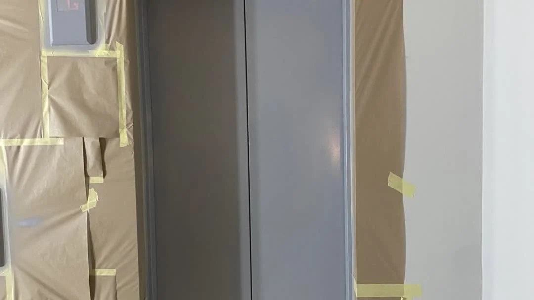 Lift lobby masked and ready for electrostatic spray application, London office building