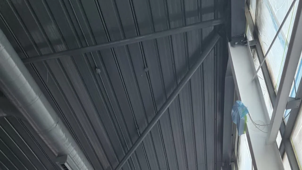 Commercial ceiling sprayed by Vanda Coatings, clean white finish on exposed structure