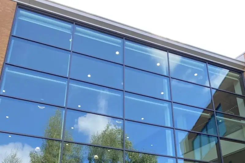 Completed curtain wall spraying on a large commercial office building by Vanda Coatings