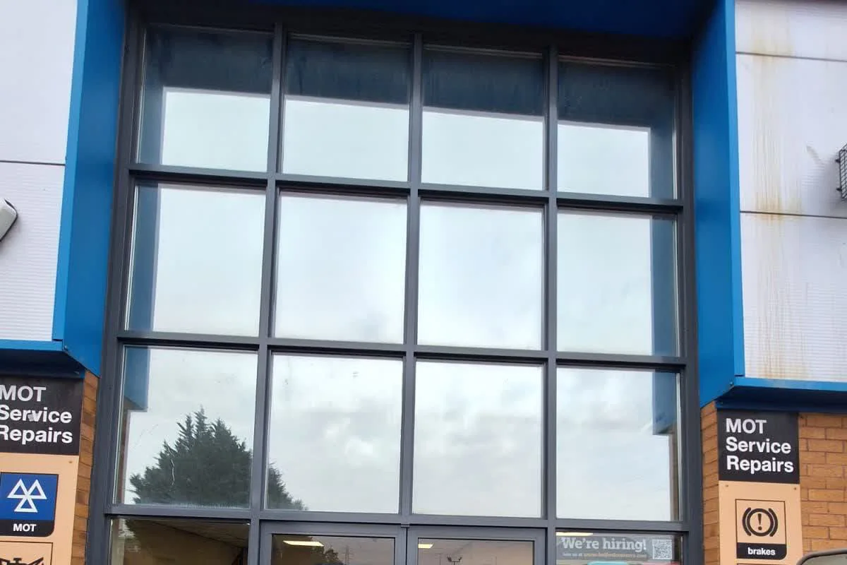 Completed shopfront and entrance metalwork resprayed in dark grey by Vanda Coatings