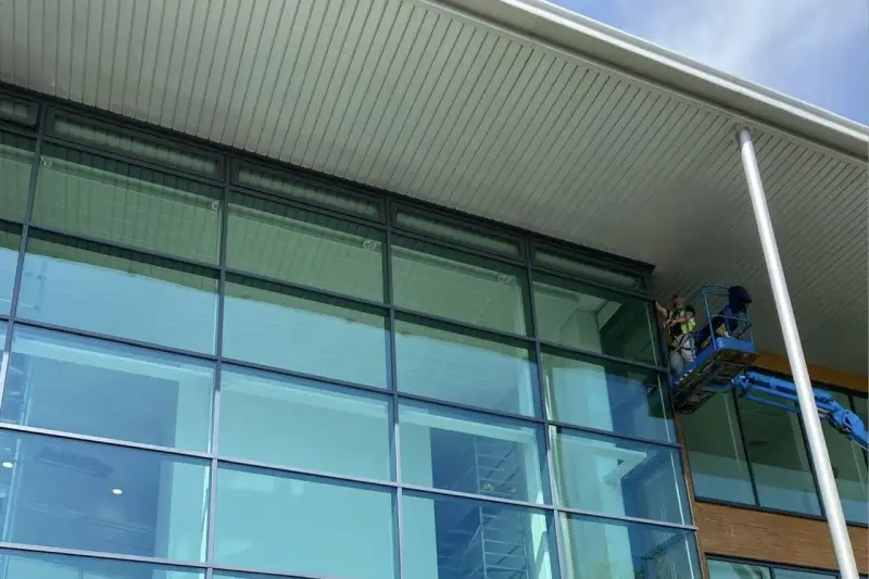 Vanda Coatings operatives on cherry picker spraying curtain walling