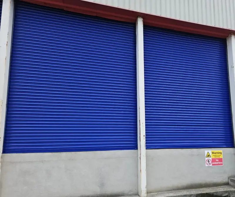 Blue roller shutter doors freshly sprayed by Vanda Coatings