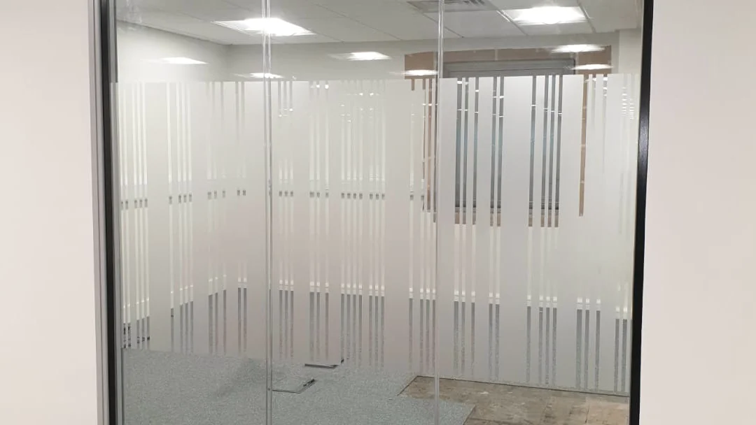 Office interior before spray painting, marked walls and worn partition metalwork