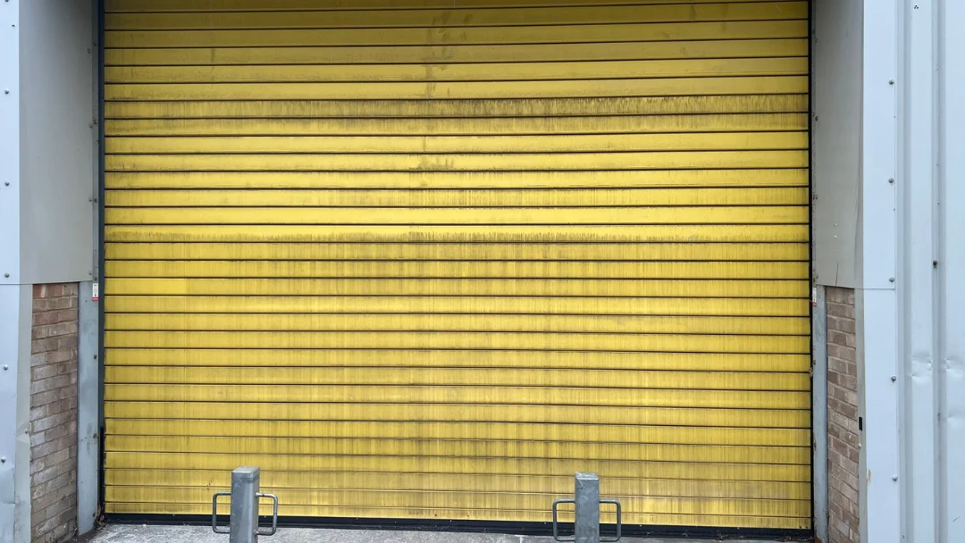 Roller shutter doors before recoating, faded and chalked finish