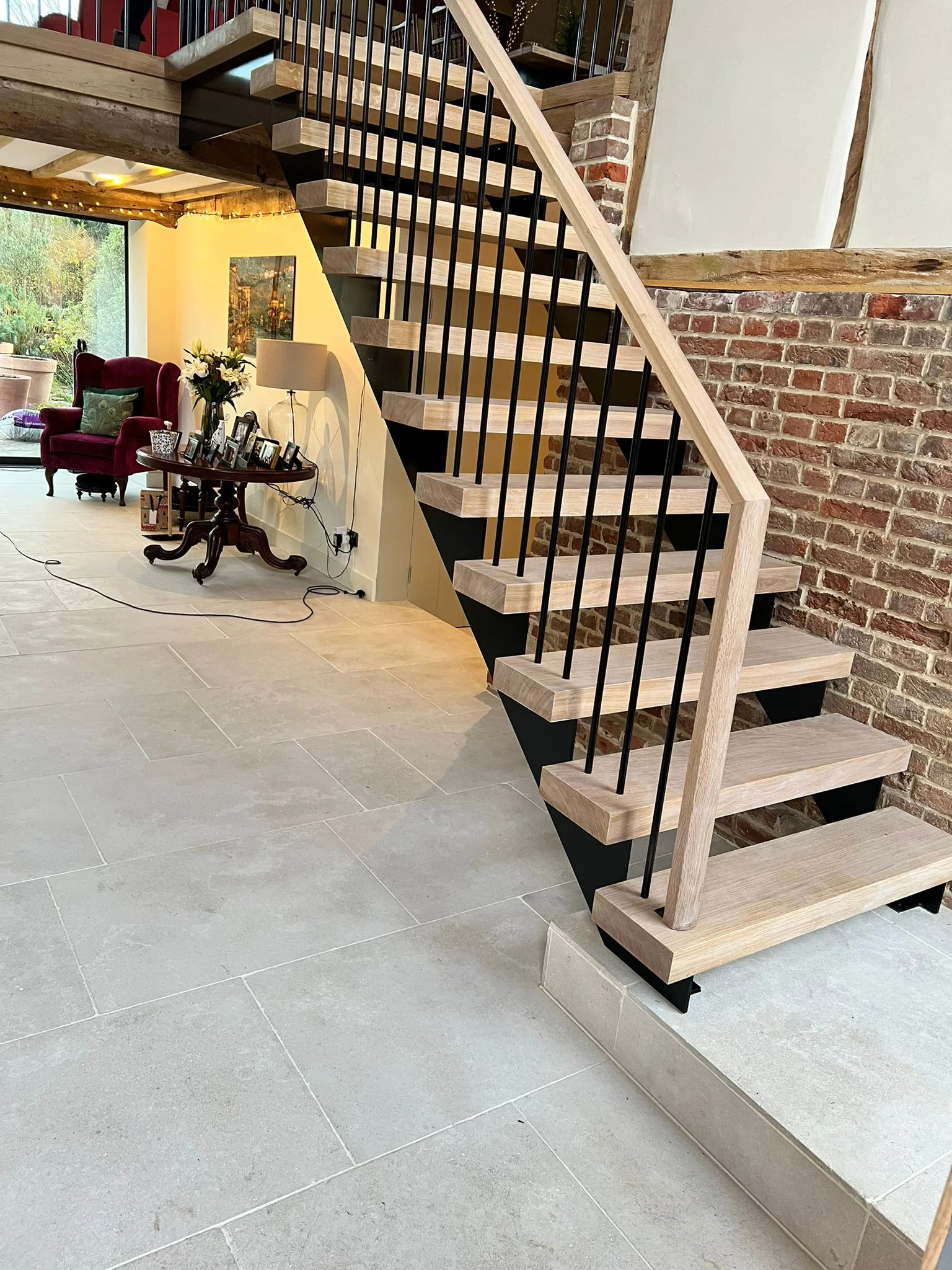 Completed black steel staircase with oak treads spray-painted on site, Wiltshire